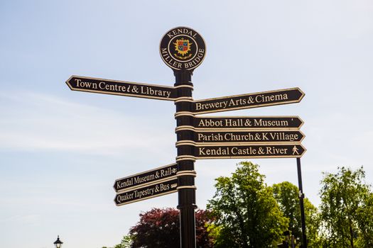 Town signpost showing directions to various places in the center of historical town Kendal. Kendal is considered as the southern gateway to the Lake District, UK