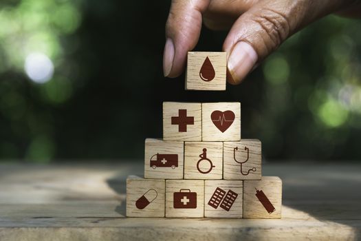 Hand holding cube dice health and medical symbols with copy space.  Healthy and medical concept.