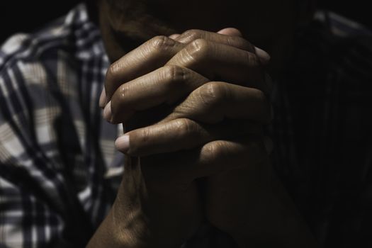 Hand of man while praying for religion. Concept peace and life.