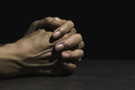 Hand of man while praying for religion. Concept peace and life.