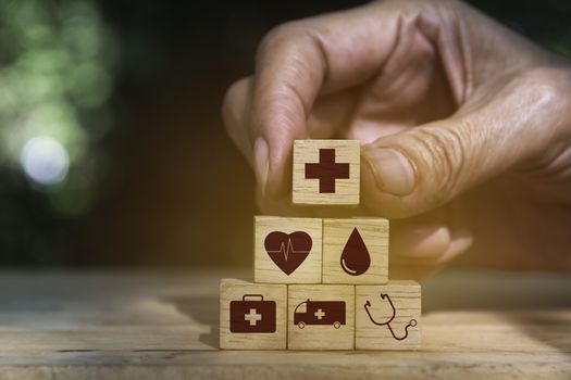 Hand holding cube dice health and medical symbols with copy space.  Healthy and medical concept.