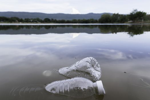 Plastic water bottles pollution in the river. Plastic trash in water. Environmental pollution concept.