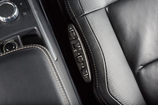 Close up of leather car seat control panel