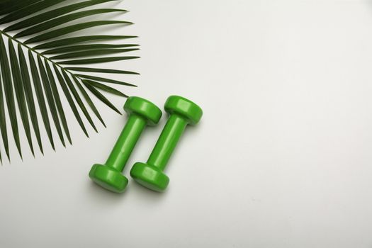 Concept preparing to fitness sports equipment with dumbbell on white background.