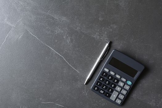 Close up of black calculator with pen and copy space. Technology and financial concept.