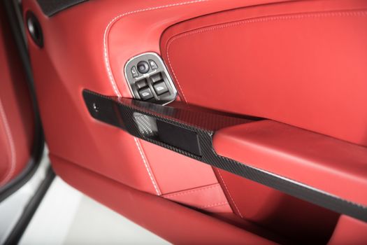 Detail of car door panel in red leather trim