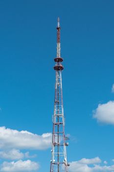 telecommunication tower with antennas on the background of the sky with clouds