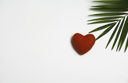 Red heart with green leaf isolated on whtie background.