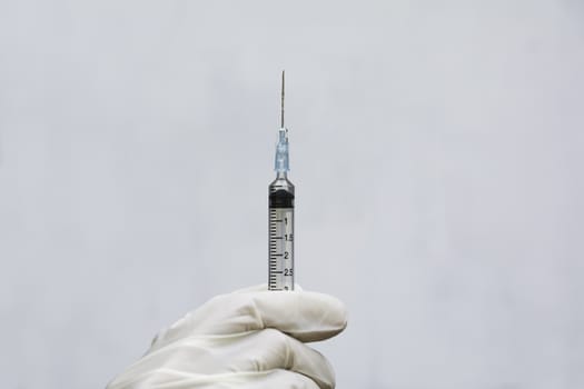 Hand of doctor holding syringe and drug, medical concept.