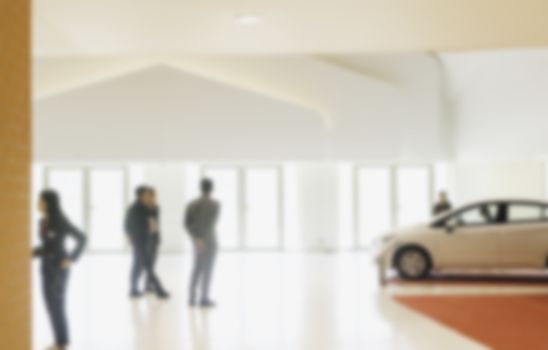 People at the cars showroom blurred background. blurred showroom car.  business and background concept.