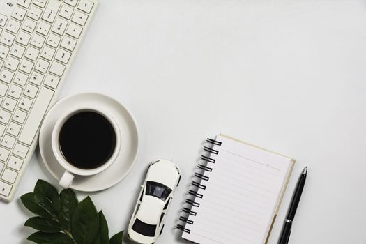 A coffee cup on white office desk with copy space. Business and workspace concept.