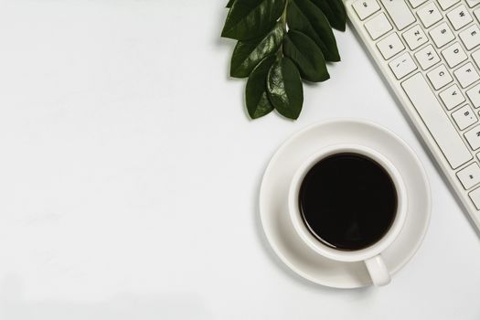 A coffee cup on white office desk with copy space. Business and workspace concept.