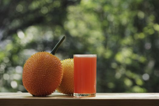 Baby Jackfruit, Gac fruit with baby jackfruit juice on blurred background. Drink and healthy concept.