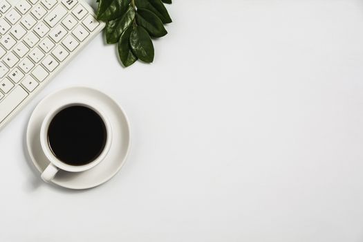 A coffee cup on white office desk with copy space. Business and workspace concept.