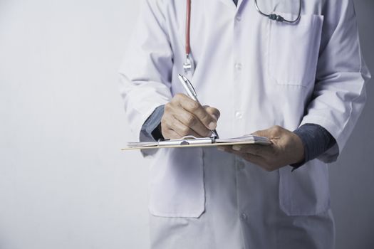 Medicine doctor with stethoscope and holding application form on white background. Healthcare and medicine.
