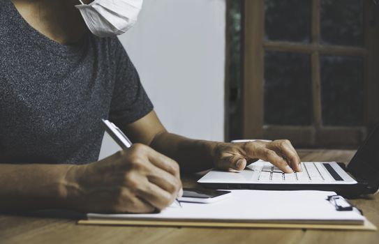 Business man working with computer laptop on wooden table at home. Working online business concept.