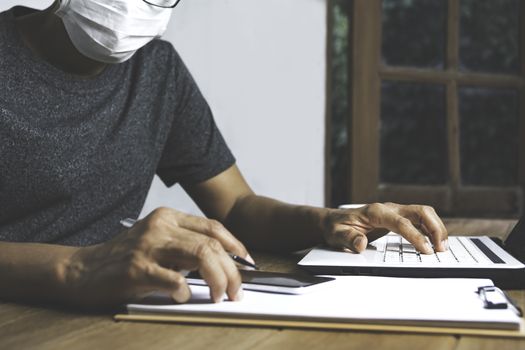 Business man working with computer laptop on wooden table at home. Working online business concept.