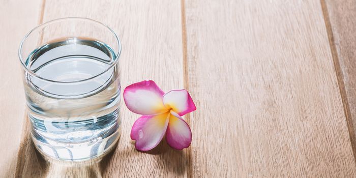 Water glass on wooden table. Glass and clean drinking water with copy space.