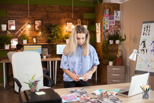 New upcoming female fashion designer working in her creative office.