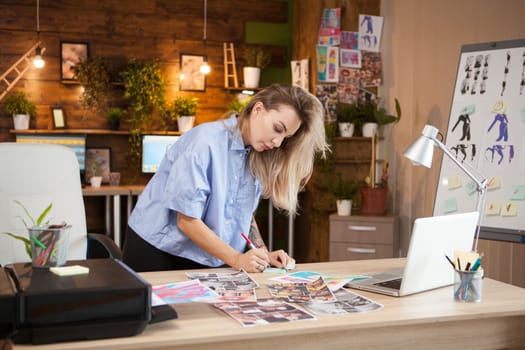 Creative female fashion designer taking notes on sticky notes.