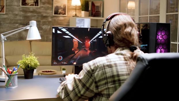 Game over for man with long hair while playing shooter games on powerful computer. Woman with vr headset.