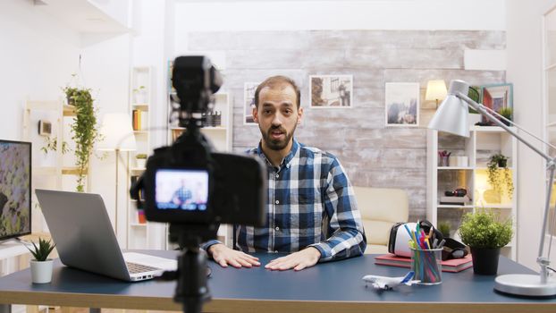 Young vlogger talking with his subscribers on social media. Creative and famous man.