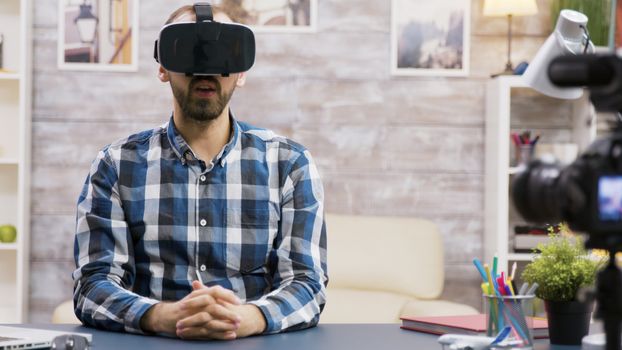 Famous influencer using virtual reality goggles while recording new episode. Creative content creator.