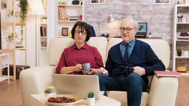 Couple of old people using modern technology. They are on a video call using laptop