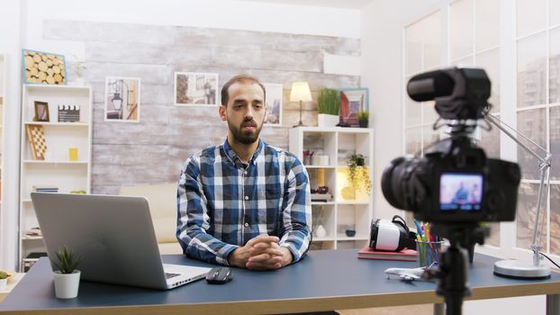 Young vlogger talking with his subscribers on social media. Creative and famous man.