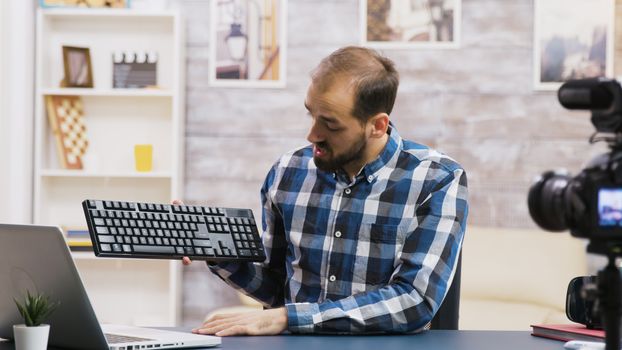 Famous vlogger filming keyboard review for his followers. Creative content creator.