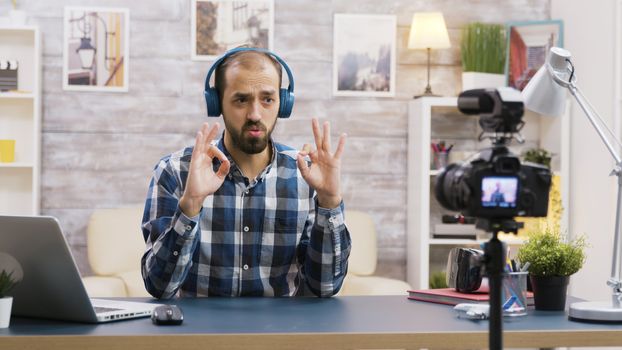 Famous influencer recording a review of a cool headphones. Creative content creator.