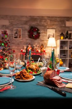 Garnished delicious roasted chicken on the table for christmas.