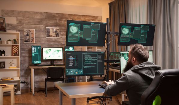 Bearded hacker in a room full of computers to attack government security.