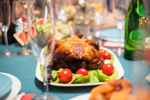 Delicious roasted chicken on the table for christmas family dinner.