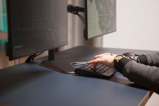 Close up of hacker hands writing a dangerous virus for cyberterrorism.