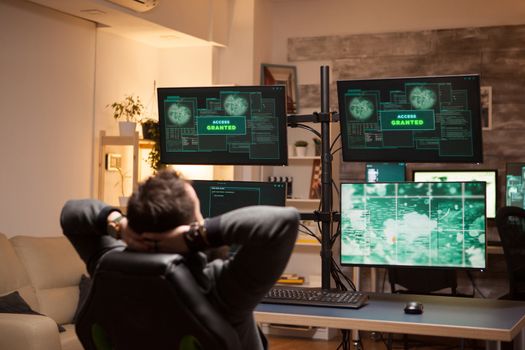 Happy hacker after a cyber attack using a dangerous malware. Access granted.