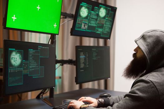 Bearded man hacking his government servers. Dangerous cyber terrorist.