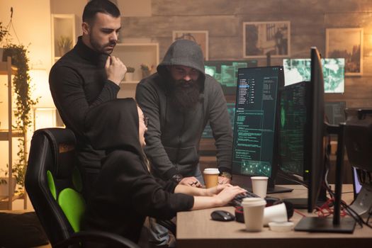 Team of men and female hackers making a dangerous malware to attack corporate servers.