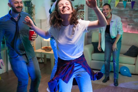 Caucasian woman full of joy at a party her cheerful friends at home