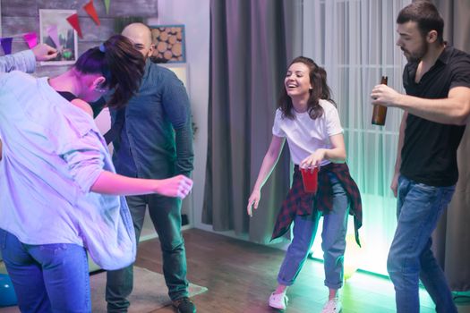 Young group of men and women celebrating their friendship at a party.