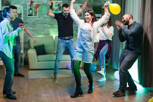 Happy young woman celebrating her birthday with her friends.