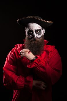 Man dressed up like a pirate for halloween with blood on his hand.