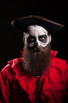 Man with a long beard dressed up like a spooky pirate for halloween.