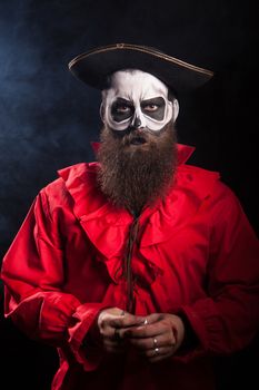 Dangerous pirate with black beard over black background for halloween.