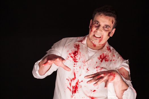 Man in shock after being possessed with blood all over his body. Creative makeup for halloween.