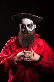 Man dressed up like a dangerous pirate for halloween over black background.