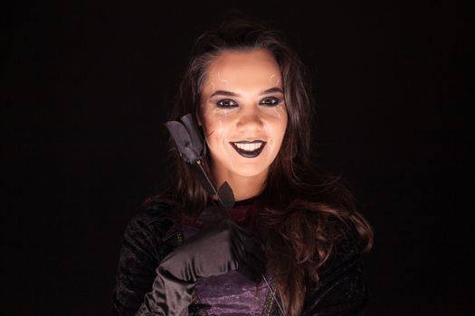 Attractive gothic woman dressed up like a witch for halloween.