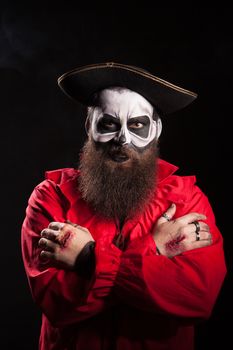 Actor with blood on his hands wearing a spooky pirate outfit.