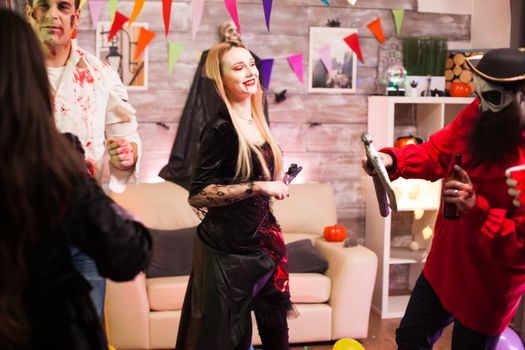 Young beautiful woman with a vampire costume at halloween celebration.