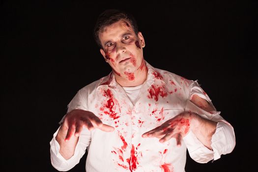 Possessed man with blood on his body over black background for halloween.